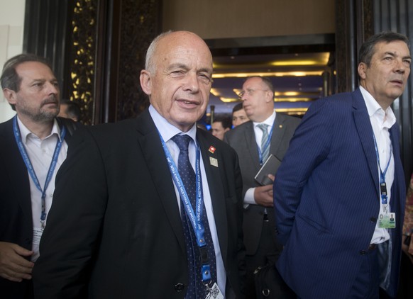 Swiss federal councillor Ueli Maurer, center, walks during the IMF and World Bank meetings in Bali, Indonesia on Saturday, Oct. 13, 2018. (AP Photo/Firdia Lisnawati)