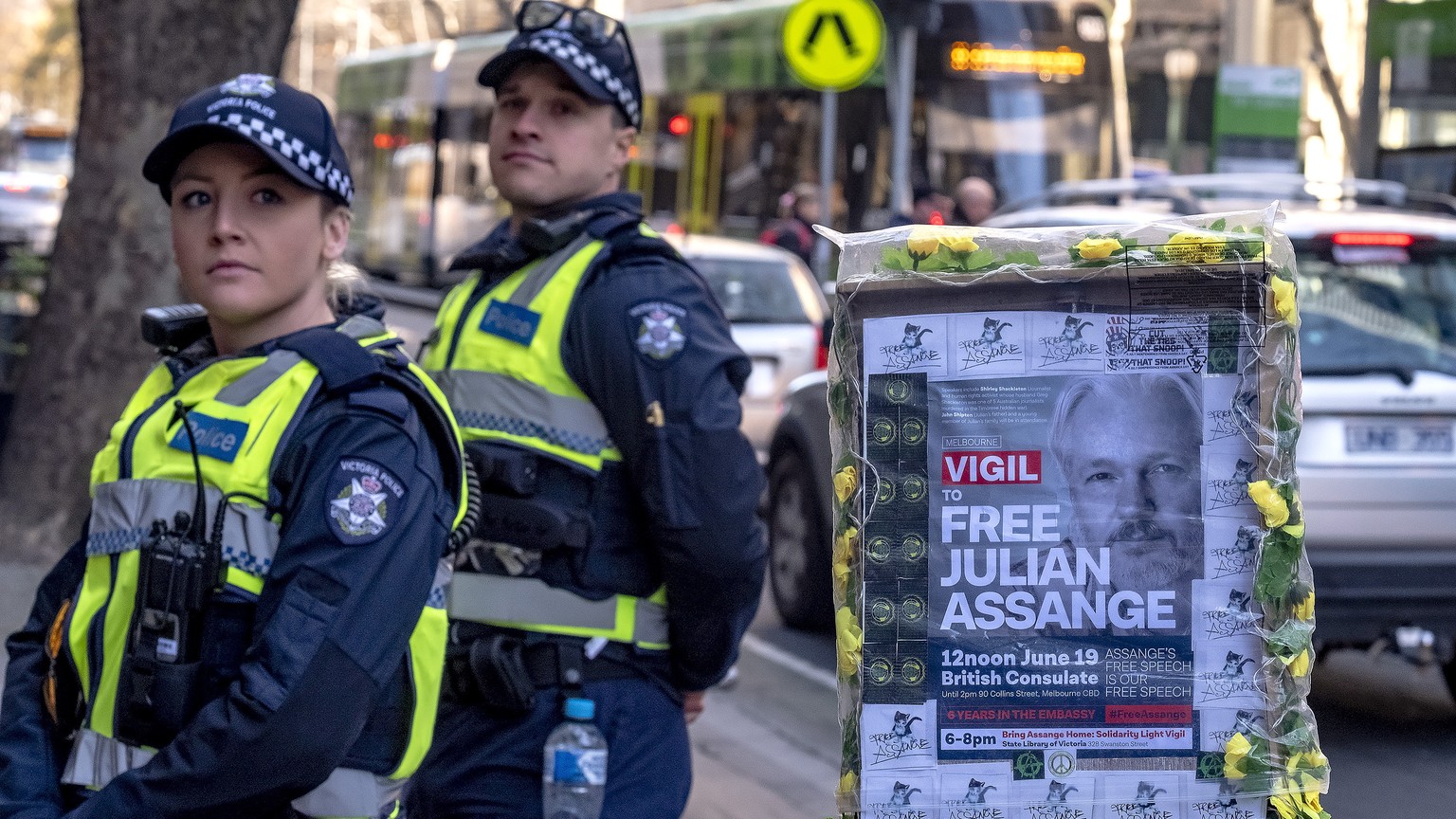 epa06820128 Police mmonitor protesters as they gather to show their support for Julian Assange during a protest outside the British consulate in Melbourne, Australia, 19 June 2018. Assange has been ho ...