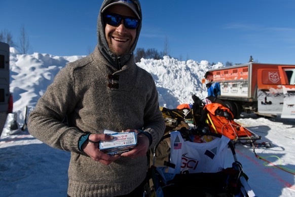 Larry Daugherty, a musher from Eagle River, will carry empty packages of COVID-19 vaccine with him on the trail this year as mushers began the Iditarod Sled Dog Race from the start area at Deshka Land ...