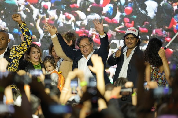 FILE - Presidential candidate Gustavo Petro, center, waves to supporters alongside his son Nicolas Petro Burgos, right, on election night in Bogota, Colombia, Sunday, May 29, 2022. Colombian police ar ...
