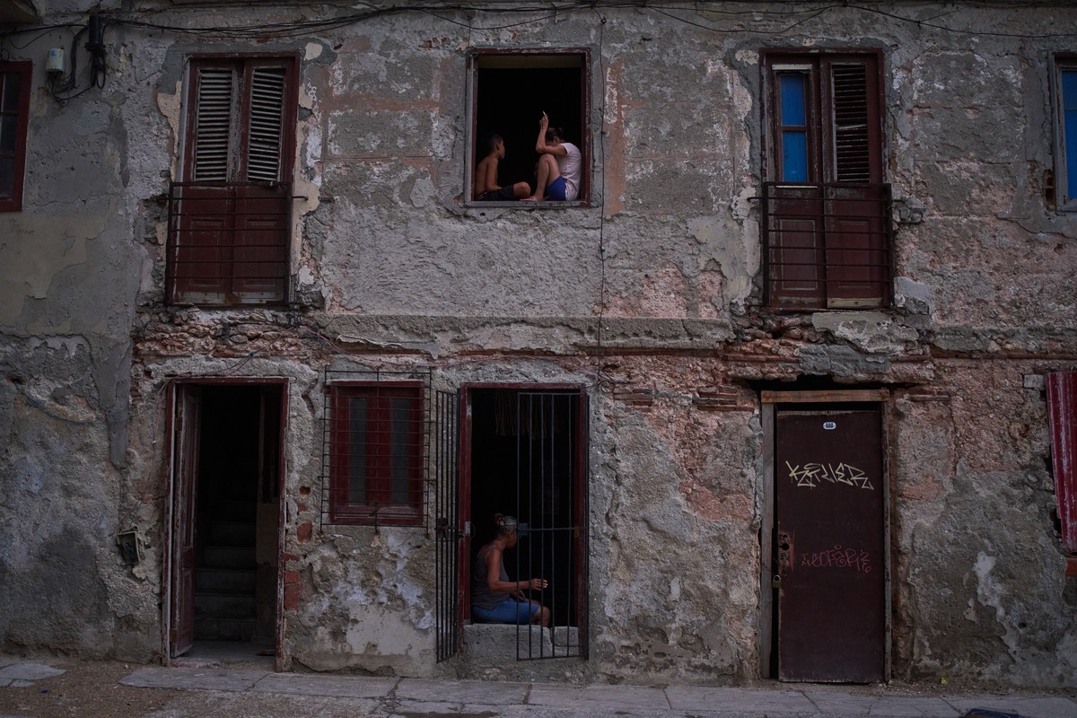 People catch the cool air from the street at their home's window during a blackout in Havana, Cuba, Friday, July 10, 2026. (AP Photo/Ramon Espinosa)
Cuba Blackout