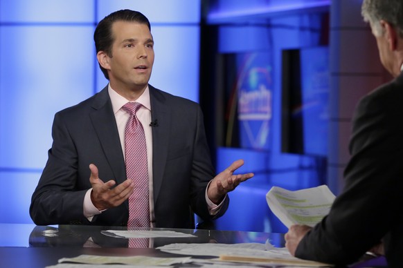 Donald Trump Jr., left, is interviewed by host Sean Hannity on his Fox News Channel television program, in New York Tuesday, July 11, 2017. Donald Trump Jr. eagerly accepted help from what was describ ...