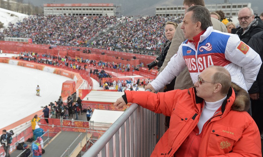 FILE - In this file photo taken Saturday, March 8, 2014, Russian President Vladimir Putin, foreground, watches downhill ski competition of the 2014 Winter Paralympics in Roza Khutor mountain district  ...