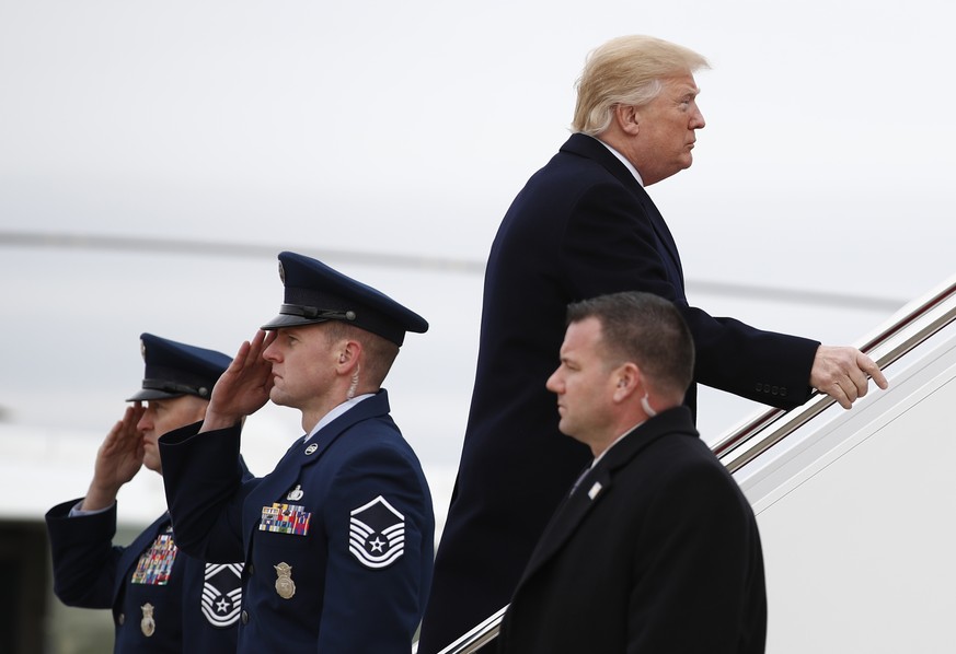 President Donald Trump boards Air Force One, Friday, Dec. 22, 2017, in Andrews Air Force Base, Md., en route to Palm Beach International Airport, in West Palm Beach, Fla. (AP Photo/Carolyn Kaster)