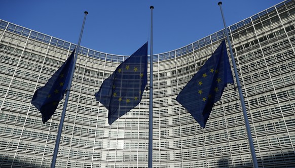 EU flags fly at half staff outside the headquarters of the EU in Brussels, Belgium, Wednesday, Dec., 12, 2018, in respect for the victims of the shooting attack at a Christmas market in Strasbourg, Fr ...
