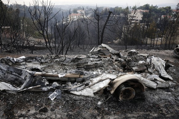 epa06907382 A view of burnt cars after a fire in Neo Voutza, northeast Attica, Greece, 24 July 2018. Another 26 charred bodies were found in Argyra Akti. At least 53 people have lost their lives in wi ...