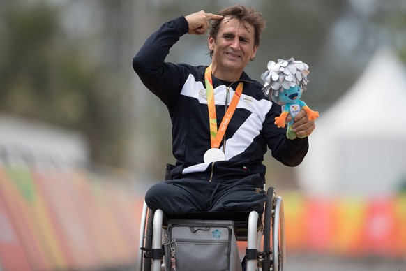 Italy&#039;s silver medalist Alessandro &quot;Alex&quot; Zanardi poses for photos during the medal ceremony for the men&#039;s road race H5 hand-cycling event, during the Paralympics Games, in Rio de  ...