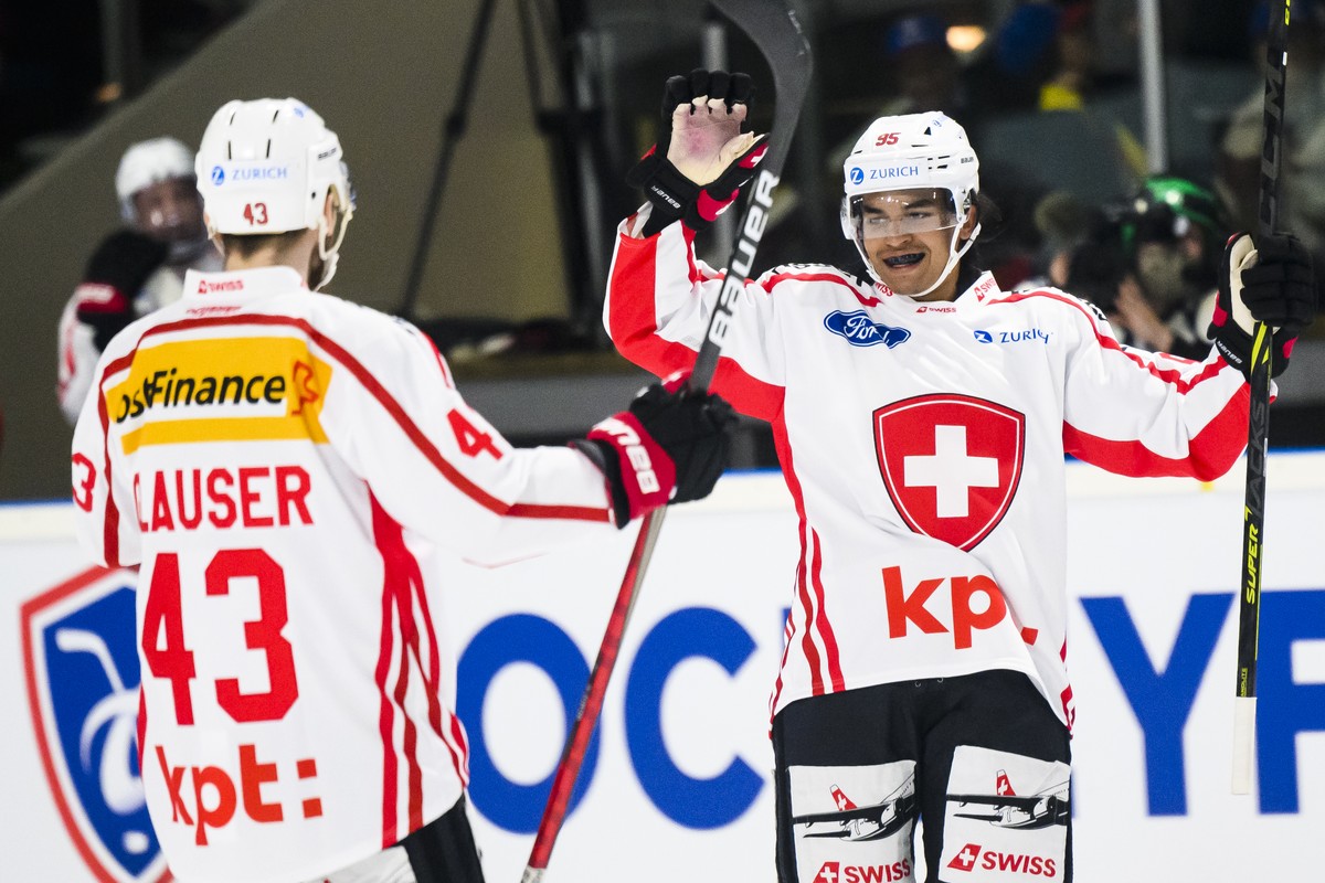 Switzerland's Noah Delemont, right, celebrates after scoring agoal with Switzerland's Andrea Glauser, left, during a friendly ice hockey match between France and Switzerland, at the Palais d ...