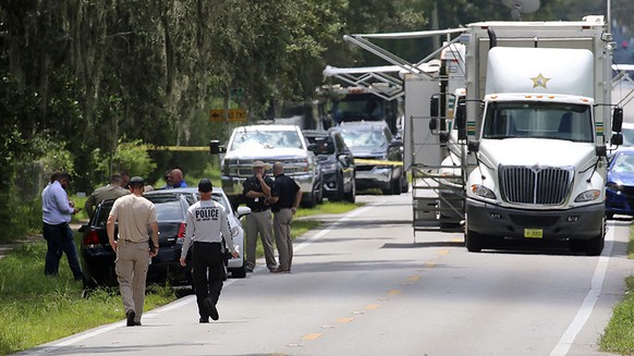 Polk County, Fla., Sheriff&#039;s officials work the scene of a multiple fatality shooting Sunday, Sept. 5, 2021, in Lakeland, Fla. Four people are dead including a mother who was still cradling her n ...