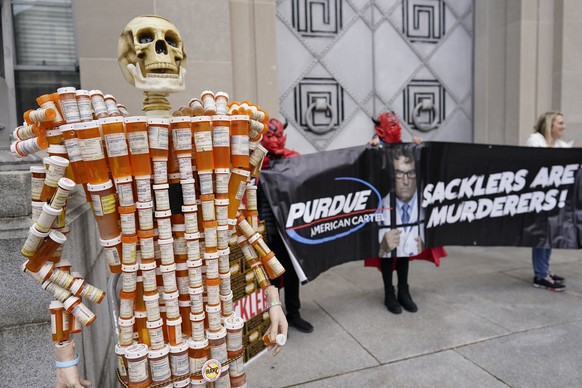 Pill Mann&quot; made by Frank Huntley of Worcester, Mass., from his opioid prescription pill bottles, is displayed during a protest by advocates for opioid victims outside the Department of Justice, F ...