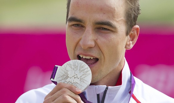 Switzerland&#039;s Nino Schurter reacts with his silver medal after the men&#039;s cycling cross country race in Hadleigh Farm in Essex, Great Britain, at the London 2012 Olympic Summer Games, picture ...