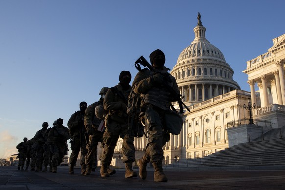 epaselect epa08934997 Firearms are issued to US National Guard troops at the East Front of the US Capitol in Washington, DC, USA, 13 January 2021. At least ten thousand troops of the National Guard wi ...