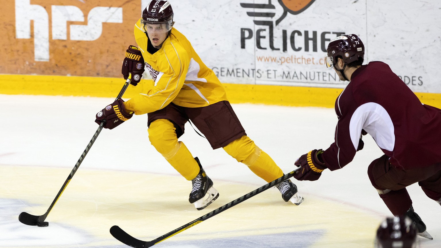 The new Geneve-Servette&#039;s forward Keanu Derungs and Geneve-Servette&#039;s forward Christophe Cavalleri, right, fight for the puck, during the first training session of the Geneve-Servette HC tea ...