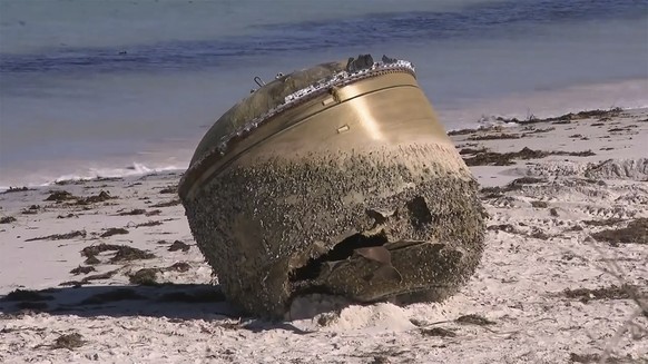 In this image made from video, a cylindrical object is seen on beach in Green Head, Australia, July 17, 2023. Authorities were investigating on Tuesday whether a cylindrical object about the size of a ...