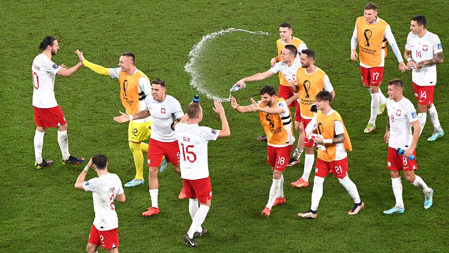 epa10340152 Players of Poland start celebrating as they learn that they will advance to the next round despite loosing the FIFA World Cup 2022 group C soccer match between Poland and Argentina at Stad ...