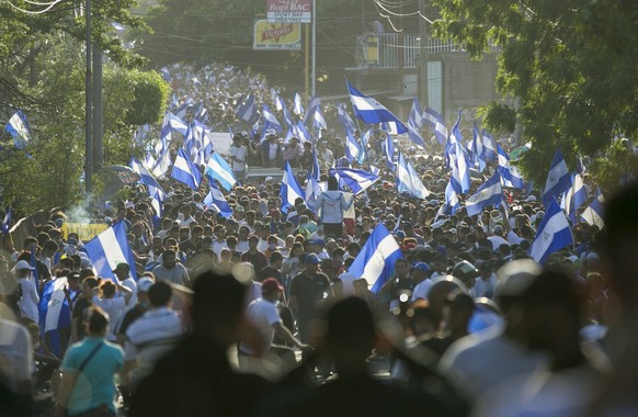 epa06688230 Hundreds of people attend a demonstration held to protest against the government of President Daniel Ortega, in Managua, Nicaragua, 23 April 2018. Thousands of protesters in Managua and ot ...