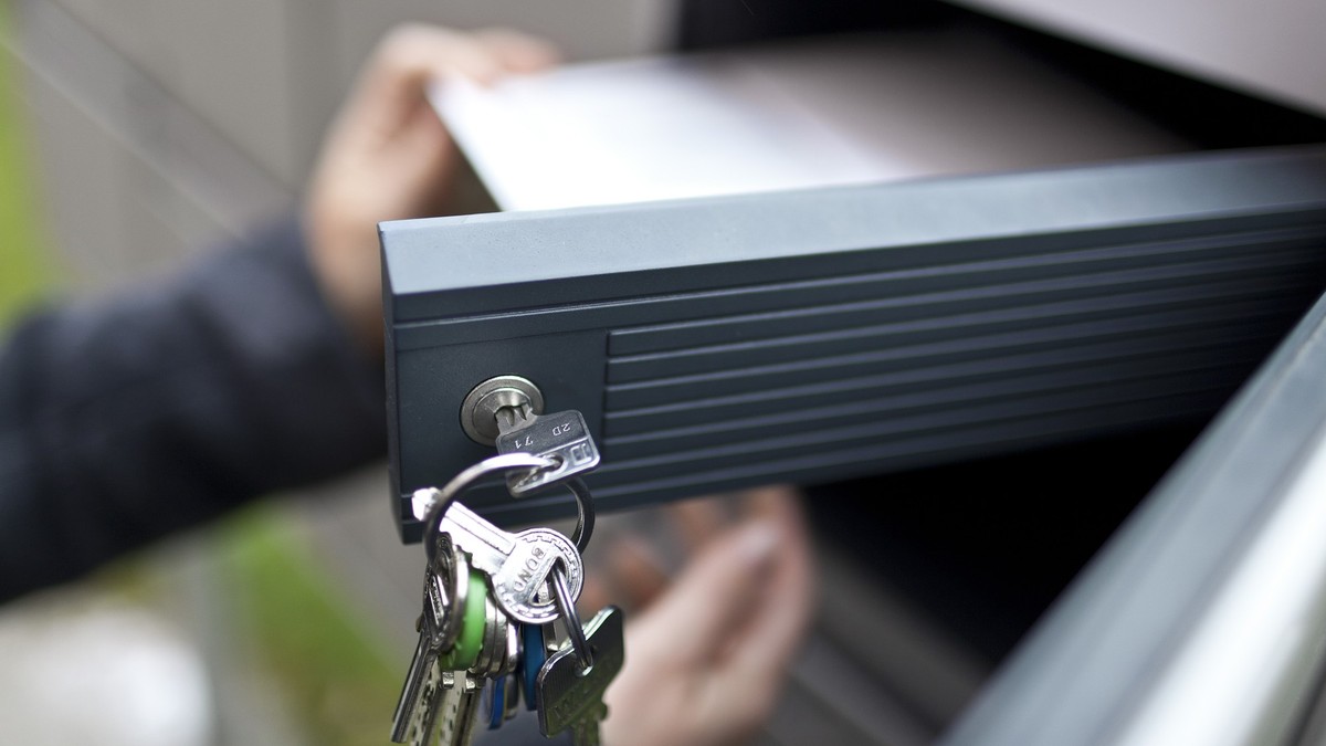 A woman gets her postal vote forms out of her letterbox on the occasion of the second tour of the election for the canton of Zurich's seat in the federal Council of States, pictured on November 2 ...