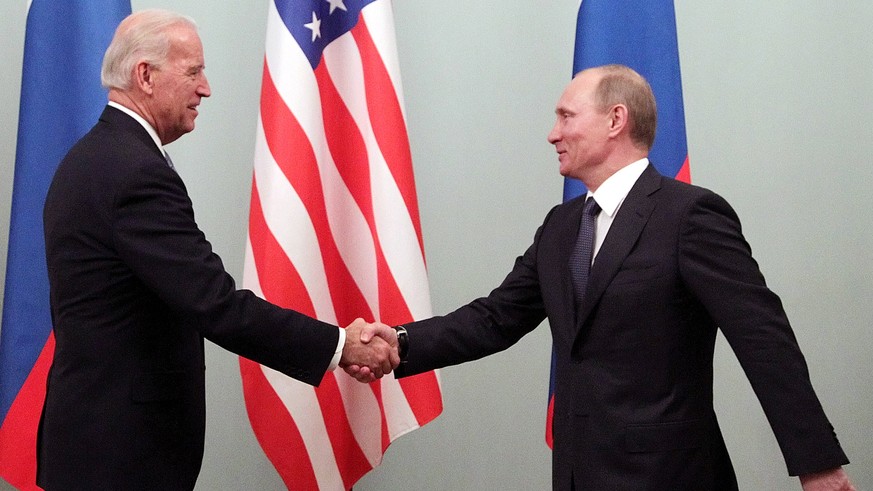 epa09226955 (FILE) - Then US Vice President Joe Biden (L) shakes hands with then Russian Prime Minister Vladimir Putin during their meeting in Moscow, Russia, 10 March 2011 (reissued 25 May 2021). Put ...