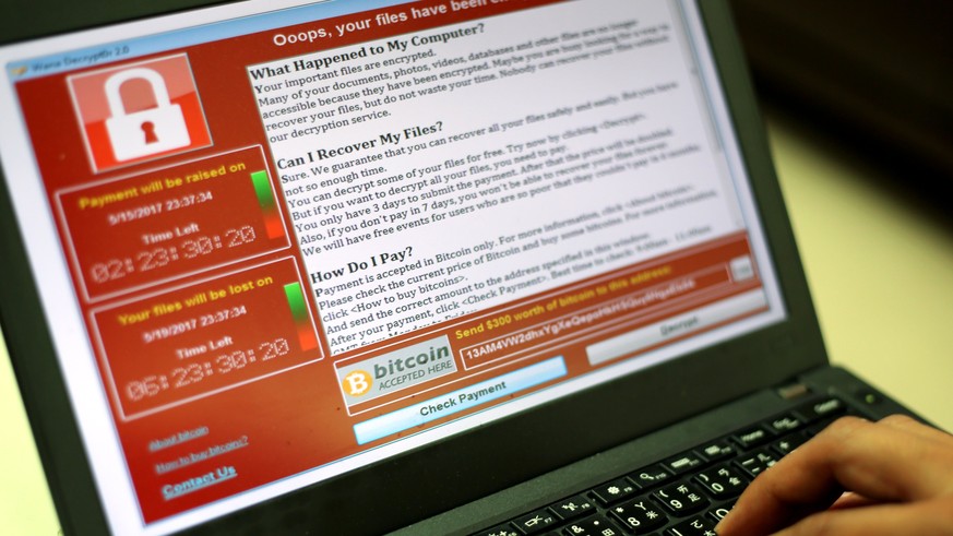 epa05960674 A programer shows a sample of a ransomware cyberattack on a laptop in Taipei, Taiwan, 13 May, 2017. According to news reports, a 'WannaCry' ransomware cyber attack hits thousands of comput ...