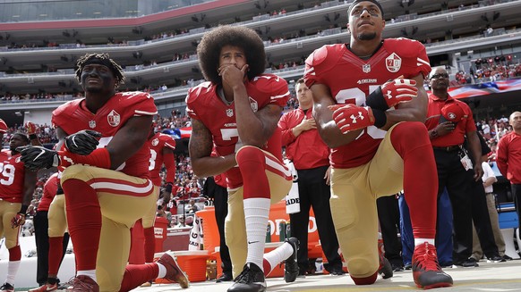 FILE - In this Oct. 2, 2016, file photo, San Francisco 49ers outside linebacker Eli Harold, left, quarterback Colin Kaepernick, center, and safety Eric Reid kneel during the national anthem before the ...