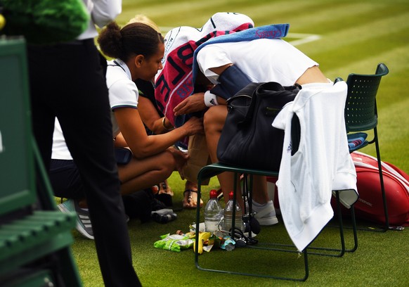 epa06863594 Andrea Petkovic of Germany during a break in play during her second round match against Yanina Wickmayer of Belgium at the Wimbledon Championships at the All England Lawn Tennis Club, in L ...