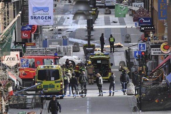 2017 AP YEAR END PHOTOS - Emergency personnel work at the scene after a truck crashed into a department store, injuring several people in central Stockholm, Sweden, on April 7, 2017. Swedish Prime Min ...