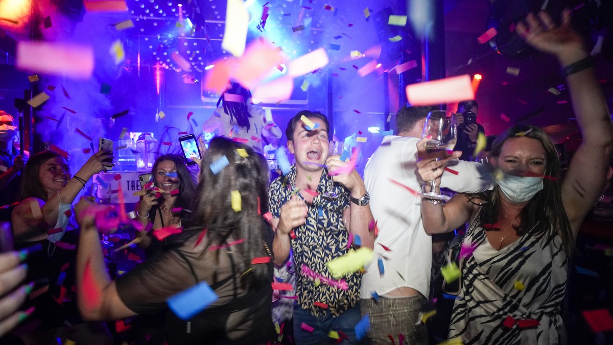 People dance shortly after the reopening, at The Piano Works in Farringdon, in London, Monday, July 19, 2021. Thousands of young people plan to dance the night away at 'Freedom Day' parties  ...