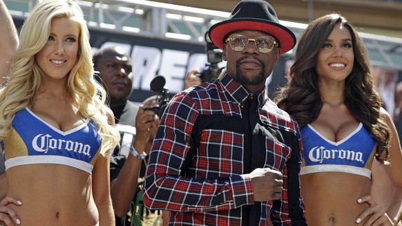 Floyd Mayweather Jr., center, stands on stage during the arrivals for their boxing match Tuesday, Aug. 22, 2017, in Las Vegas. Mayweather is scheduled to fight Conor McGregor in a boxing match Saturda ...