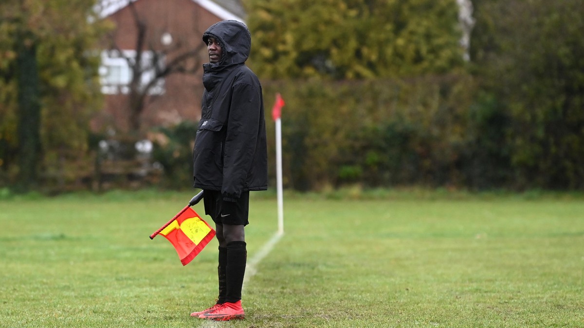 epa09060958 (24/25) Sanctuary Strikers Football Club player Adam Hussai acts as a lines-man as his team play against Goring United in Goring-On-Thames, Britain, 13 December 2020 (issued 08 March 2021) ...