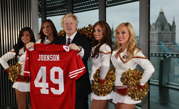 FILE - In this Tuesday, Oct., 26, 2010 file photo Boris Johnson, then Mayor of London center, and four of the 49ers cheerleaders Deanna Ortega, left, Morgan McLeod, Alexis Kofoed and Lauren Riccaboni, ...