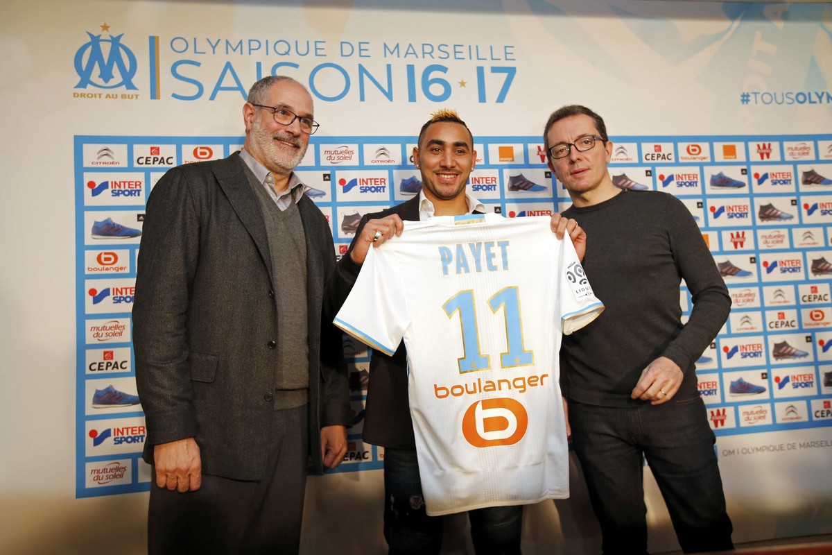 Olympique Marseille's latest recruit Dimitri Payet (C) displays his new jersey with Olympique Marseille President Jacques-Henri Eyraud (R) and Sport Director Andoni Zubizarreta after a news confe ...