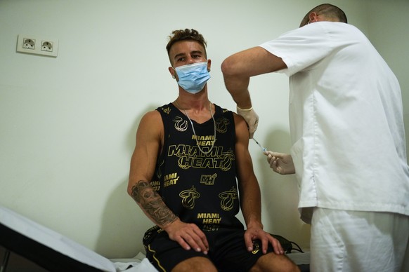 A man receives a vaccine against Monkeypox from a health professional in medical center in Barcelona, Spain, Tuesday, July 26, 2022. (AP Photo/Francisco Seco)