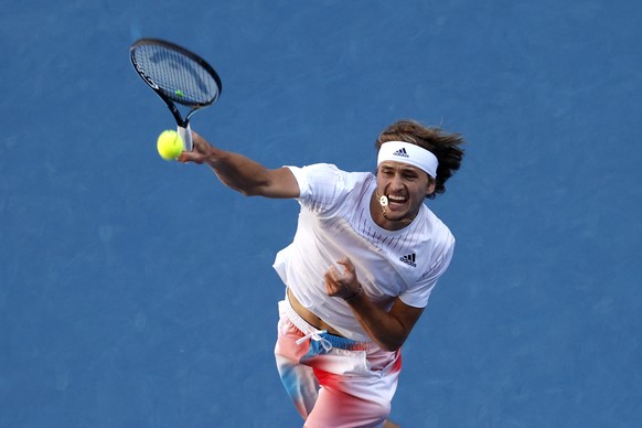 Alexander Zverev of Germany plays a forehand return to Radu Albot of Moldova during their third round match at the Australian Open tennis championships in Melbourne, Australia, Friday, Jan. 21, 2022.  ...