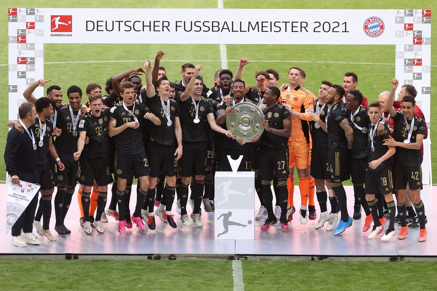 epa09222069 The FC Bayern Muenchen team celebrate with the Bundesliga Meisterschale trophy following the Bundesliga match between FC Bayern Muenchen and FC Augsburg at Allianz Arena in Munich, Germany ...