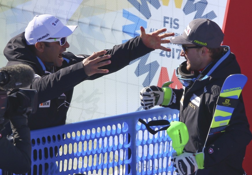 Alpine Skiing - FIS Alpine Skiing World Championships - Men&#039;s Alpine Combined - Slalom - St. Moritz, Switzerland - 13/2/17 - Switzerland&#039;s Luca Aerni (R) is congratulated by an unidentified  ...