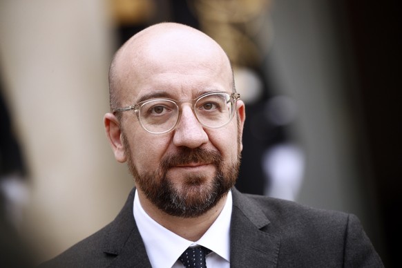 epa08059759 President of the European Council Charles Michel looks on while addressing the media with French President Macron, upon his arrival at the Elysee Palace in Paris, France, 10 December 2019. ...