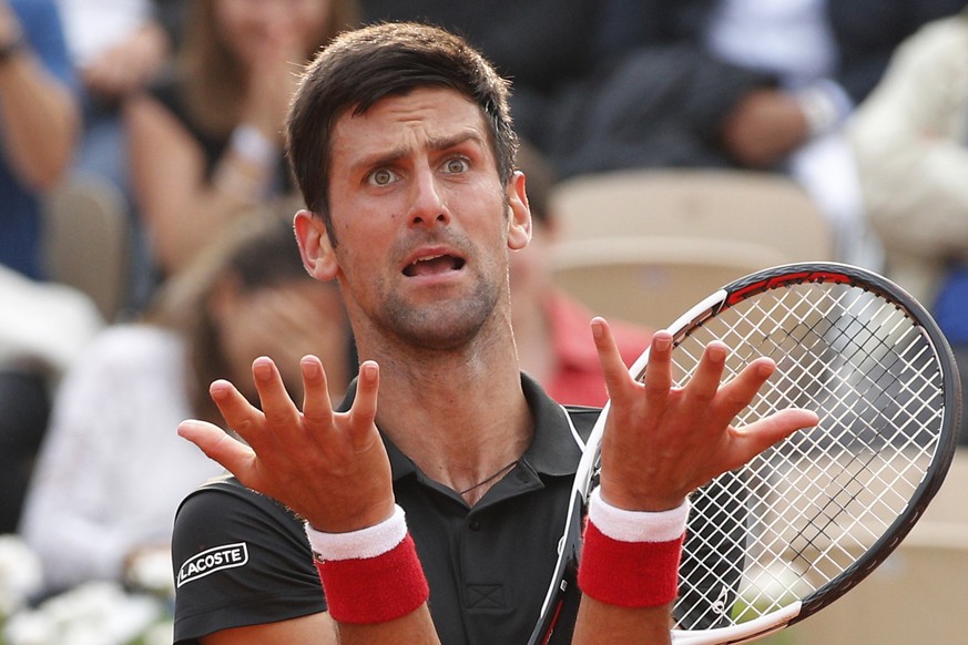 Serbia&#039;s Novak Djokovic reacts after missing a shot against Italy&#039;s Marco Cecchinato in the tie break of the fourth set of their quarterfinal match at the French Open tennis tournament at th ...