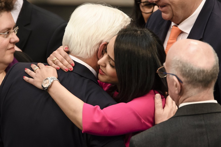 epa05863423 Berlin state secretary Sawsan Chebli (C) congratulates New German President Frank-Walter Steinmeier (L) after Steinmeier being sworn-in at the &#039;Bundestag&#039; parliament in Berlin, G ...