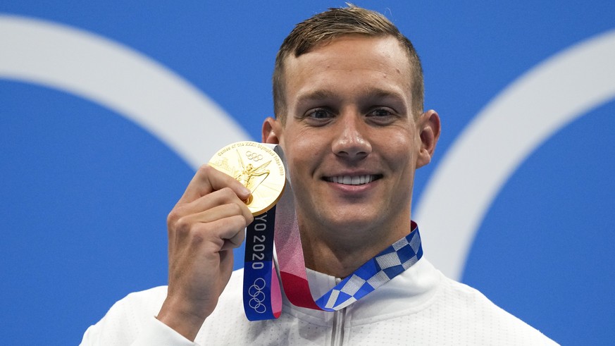 Caeleb Dressel, of United States, poses after winning the gold medal in the men's 50-meter freestyle final at the 2020 Summer Olympics, Sunday, Aug. 1, 2021, in Tokyo, Japan. (AP Photo/Gregory Bull)
