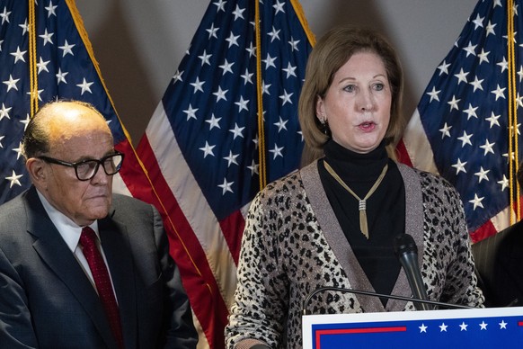 FILE - Sidney Powell, right, speaks next to former Mayor of New York Rudy Giuliani, as members of President Donald Trump&#039;s legal team, during a news conference at the Republican National Committe ...