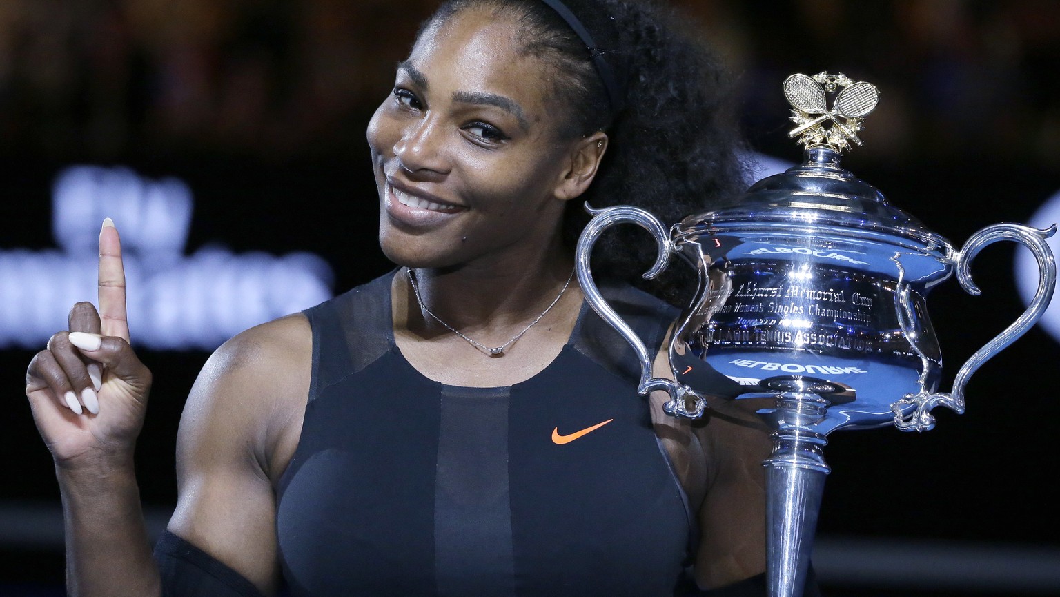 FILE - In this Jan. 28, 2017, file photo, Serena Williams holds up a finger and her trophy after defeating her sister, Venus, in the women&#039;s singles final at the Australian Open tennis championsh ...
