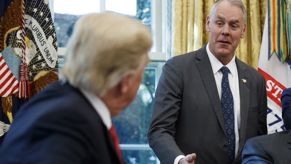 epa07233435 (FILE) - US President Donald J. Trump listens as US Secretary of the Interior Ryan Zinke (R) delivers remarks during a meeting with workers on 'Cutting the Red Tape, Unleashing Econom ...