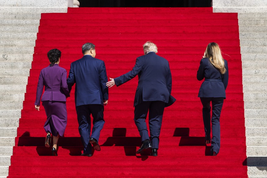 epa13263055 US President Donald Trump (C-R) and First Lady Melania Trump (R) escort Chinese President Xi Jinping (C-L) and First Lady of China Peng Liyuan (L) to the National Archives in Washington, D ...