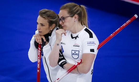 Switzerland skip Silvana Tirinzoni, left, and fourth Alina Paetz discuss strategy against the United States during a semifinal at the women���s world curling championships Saturday, May 8, 2021, in Ca ...