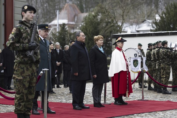 Swiss President Viola Amherd, centre right, and Chinese Prime Minister Li Qiang listen to the national anthems during their meeting in Kehrsatz, near Bern, Switzerland, Monday, Jan. 15, 2024. Chinese  ...