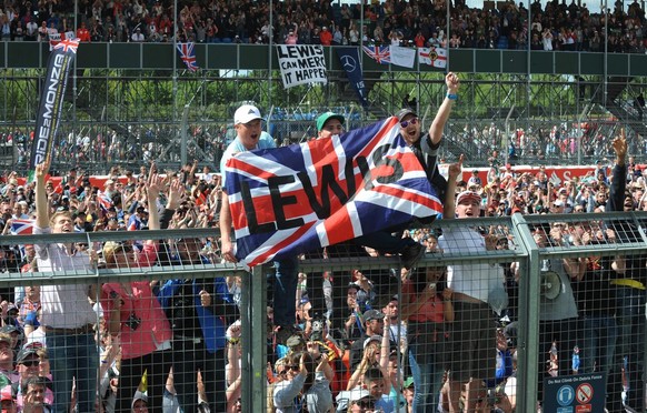 Motor racing fans celebrate after Britain&#039;s Lewis Hamilton of Mercedes won the British Formula One Grand Prix at Silverstone, England, on Sunday, July 6, 2014. Finland&#039;s Valtteri Bottas of W ...