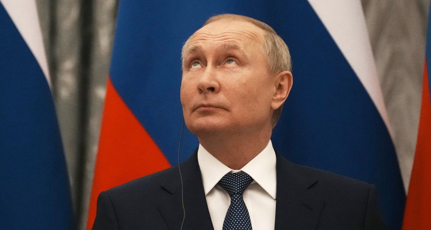 epa09736555 Russian President Vladimir Putin looks up during a press conference with French President Emmanuel Macron after their talks in the Kremlin in Moscow, Russia, 07 February2022. International ...