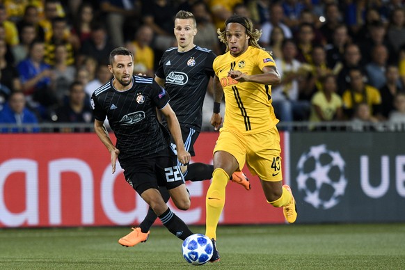 YB&#039;s Kevin Mbabu, right, shoots to score 1-0, with Zagreb&#039;s Marin Leovac, left, during the UEFA Champions League playoff match between Switzerland&#039;s BSC Young Boys and Croatia&#039;s GN ...