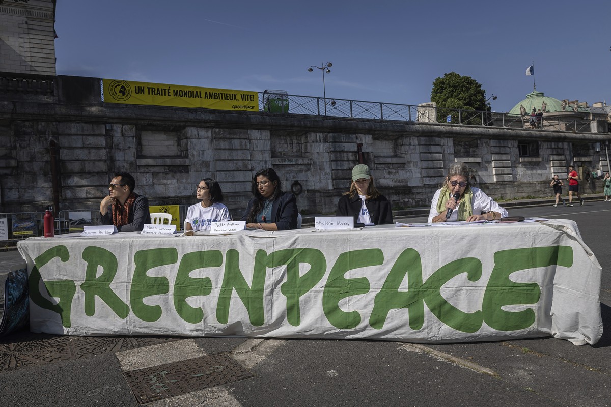 FILE - Members of Greenpeace press conference next to a giant art installation called 'Perpetual Plastic Machine' ahead of Global Plastic Treaty talks Saturday, May 27, 2023 in Paris. (AP Ph ...