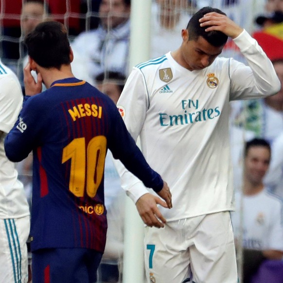 FC Barcelona Barca s Argentine forward Lionel Messi L stands next to Real Madrid s Portuguese forward Cristiano Ronaldo during the Spanish Primera Division League s soccer match between Real Madrid an ...